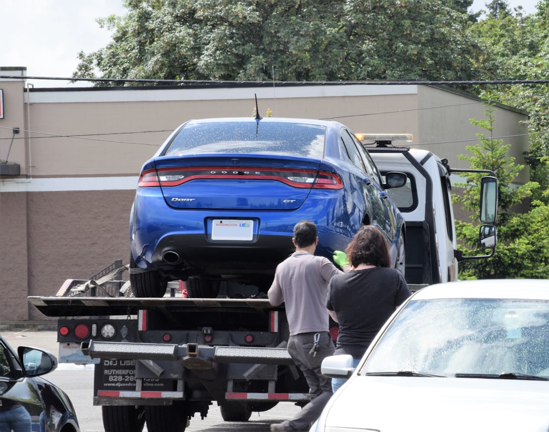 hero-gallery-01 a-blue-car-being-loaded-onto-a-flatbed-truck-uanilb8zkta